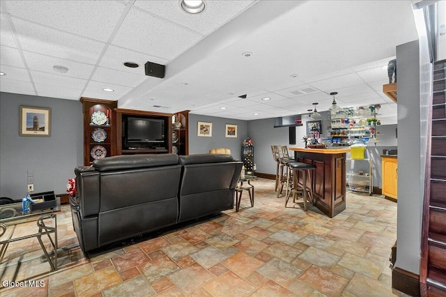 7 Marquette Ave, Colonie, NY 12110 - living area featuring a drop ceiling, a bar, light stone finish flooring, and recessed lighting