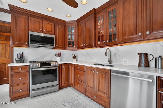 7 Marquette Ave, Colonie, NY 12110 - kitchen featuring appliances with stainless steel finishes, decorative backsplash, light countertops, light tile patterned floors, and glass insert cabinets