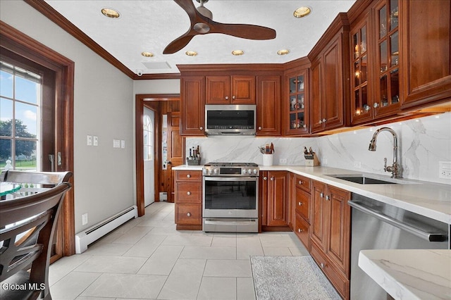 7 Marquette Ave, Colonie, NY 12110 - kitchen with appliances with stainless steel finishes, a baseboard radiator, backsplash, ornamental molding, and recessed lighting