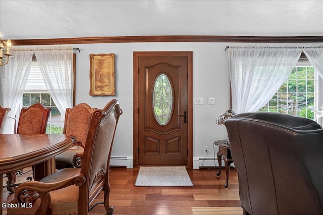 7 Marquette Ave, Colonie, NY 12110 - foyer with baseboard heating, light wood-style flooring, and crown molding