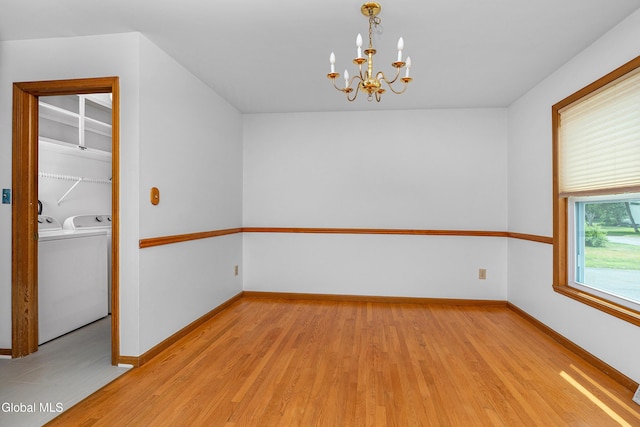 3002 Morgan Ct, Schenectady, NY 12306 - unfurnished room featuring light wood-style floors, a chandelier, and washing machine and clothes dryer