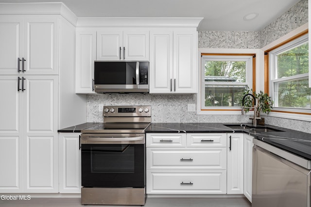 3002 Morgan Ct, Schenectady, NY 12306 - kitchen with stainless steel appliances, dark countertops, and white cabinets