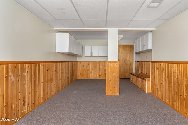 3002 Morgan Ct, Schenectady, NY 12306 - basement featuring wooden walls, a wainscoted wall, a paneled ceiling, and carpet