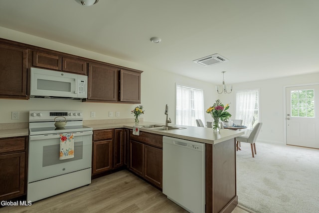 424 Summit Ave, Schenectady, NY 12307 - kitchen featuring white appliances, a peninsula, a chandelier, and light countertops