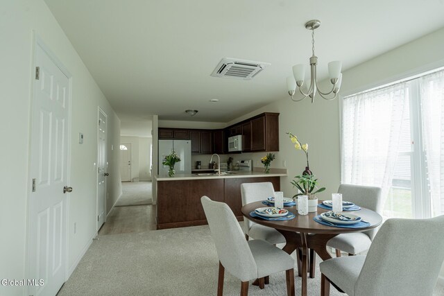 424 Summit Ave, Schenectady, NY 12307 - dining room with light colored carpet and a chandelier