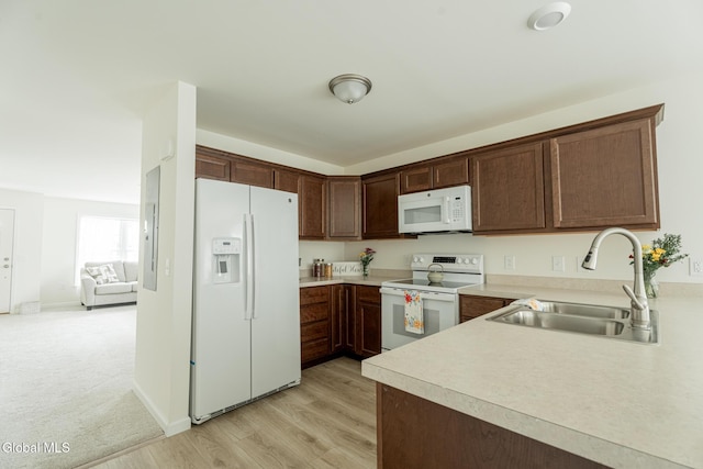 424 Summit Ave, Schenectady, NY 12307 - kitchen with white appliances, light countertops, light wood-style floors, and dark brown cabinets