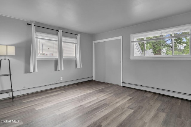 6 Briarwood Rd, Colonie, NY 12211 - unfurnished bedroom with a baseboard radiator, a baseboard heating unit, wood finished floors, and a closet