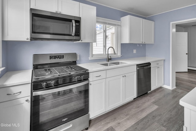 6 Briarwood Rd, Colonie, NY 12211 - kitchen featuring stainless steel appliances, light wood-style floors, white cabinetry, and light countertops