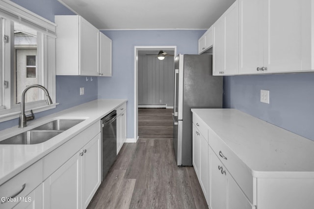 6 Briarwood Rd, Colonie, NY 12211 - kitchen with stainless steel appliances, dark wood-type flooring, white cabinetry, a baseboard heating unit, and light countertops