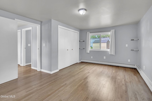 6 Briarwood Rd, Colonie, NY 12211 - unfurnished room featuring a baseboard heating unit and wood finished floors