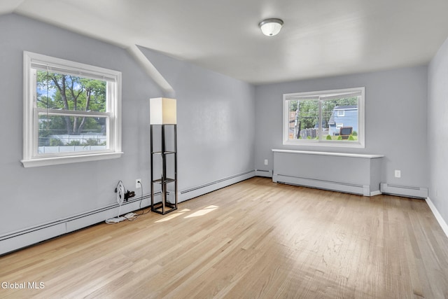 6 Briarwood Rd, Colonie, NY 12211 - additional living space featuring baseboard heating, a baseboard heating unit, wood finished floors, plenty of natural light, and lofted ceiling