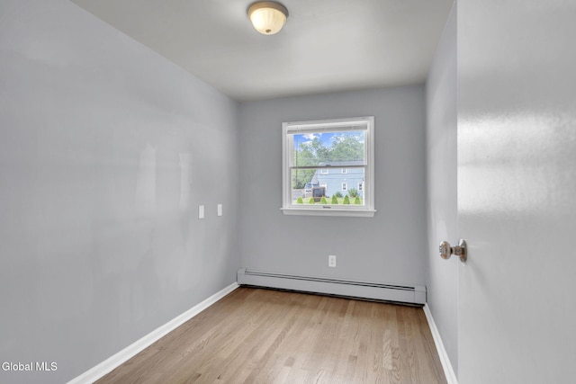 6 Briarwood Rd, Colonie, NY 12211 - empty room with baseboard heating and wood finished floors