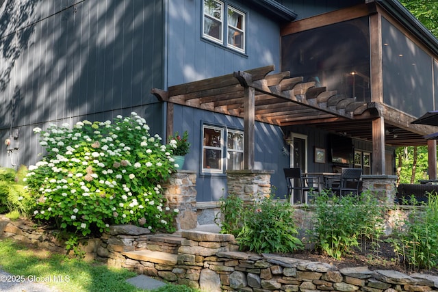 83 Pilot Knob Rd, Queensbury, NY 12804 - doorway to property with stone siding and a pergola