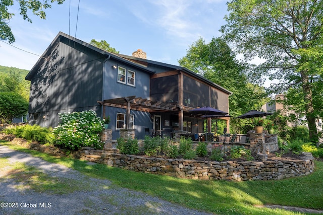 83 Pilot Knob Rd, Queensbury, NY 12804 - rear view of property with a pergola, a chimney, a sunroom, and a patio area