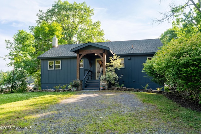 83 Pilot Knob Rd, Queensbury, NY 12804 - view of front of house featuring roof with shingles, a chimney, and a front lawn