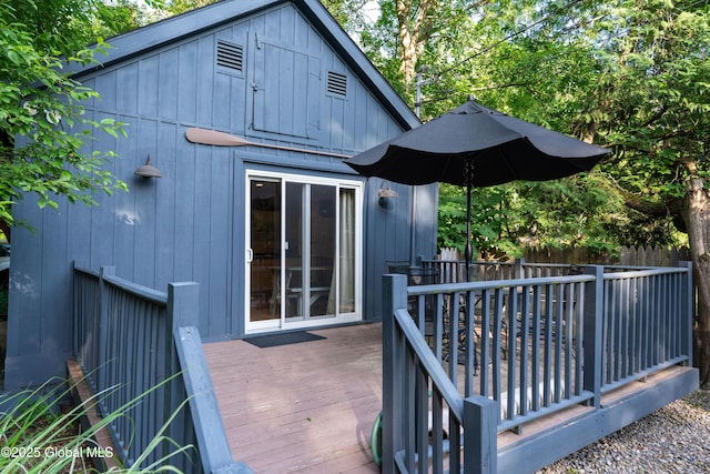 83 Pilot Knob Rd, Queensbury, NY 12804 - back of property with a wooden deck, board and batten siding, and an outbuilding