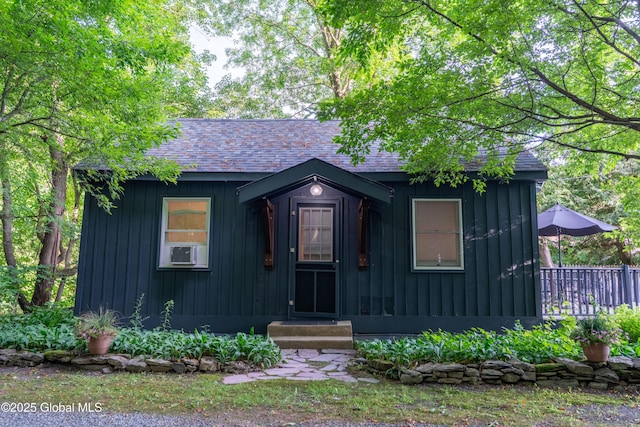 83 Pilot Knob Rd, Queensbury, NY 12804 - view of front facade featuring board and batten siding, roof with shingles, and cooling unit