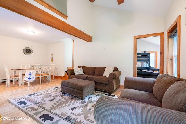 83 Pilot Knob Rd, Queensbury, NY 12804 - living room with light wood-style floors, lofted ceiling, a ceiling fan, and a baseboard heating unit