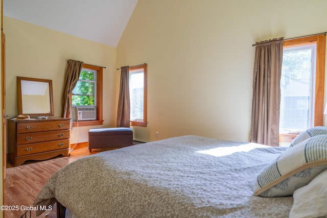 83 Pilot Knob Rd, Queensbury, NY 12804 - bedroom featuring wood finished floors, vaulted ceiling, cooling unit, and a baseboard radiator