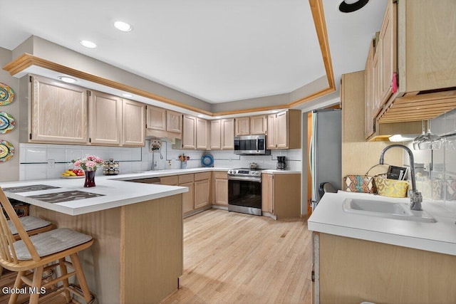 3 Pine Ridge Rd, Saratoga Springs, NY 12866 - kitchen with appliances with stainless steel finishes, a peninsula, light countertops, backsplash, and recessed lighting