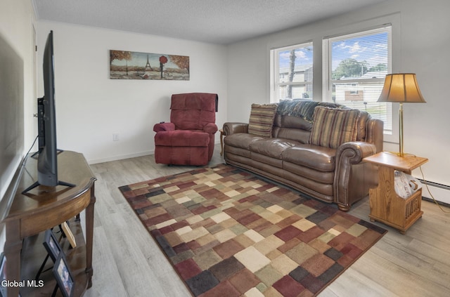 27 Wendell Dr, Colonie, NY 12205 - living area featuring light wood-type flooring, a textured ceiling, and a baseboard heating unit