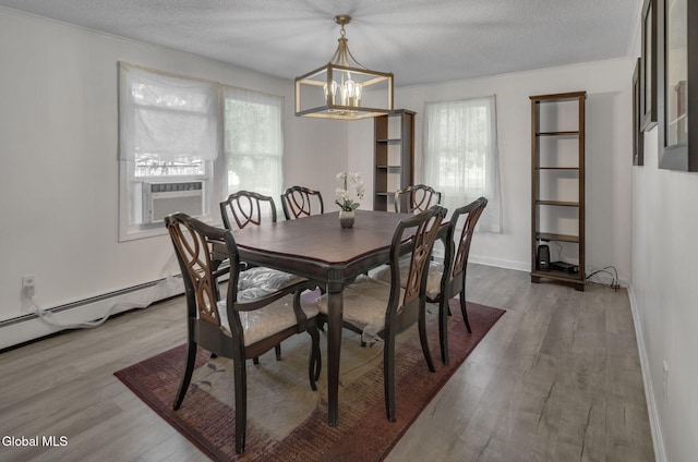 27 Wendell Dr, Colonie, NY 12205 - dining area featuring a chandelier, plenty of natural light, wood finished floors, and a textured ceiling