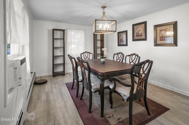 27 Wendell Dr, Colonie, NY 12205 - dining room featuring a chandelier, light wood-type flooring, and a baseboard radiator
