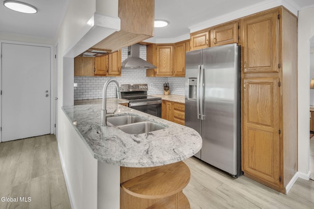 27 Wendell Dr, Colonie, NY 12205 - kitchen with stainless steel appliances, wall chimney exhaust hood, a peninsula, and light wood-style flooring