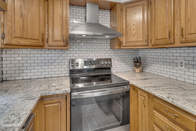 27 Wendell Dr, Colonie, NY 12205 - kitchen with electric stove, wall chimney exhaust hood, backsplash, brown cabinets, and light stone countertops