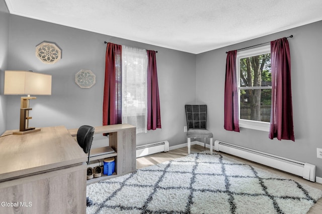 27 Wendell Dr, Colonie, NY 12205 - office area featuring a baseboard radiator, wood finished floors, and a textured ceiling