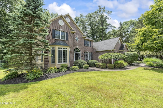 222 Bell Ct, Guilderland, NY 12303 - view of front of house featuring brick siding and a front yard
