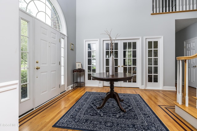 222 Bell Ct, Guilderland, NY 12303 - foyer with a high ceiling, healthy amount of natural light, and wood finished floors