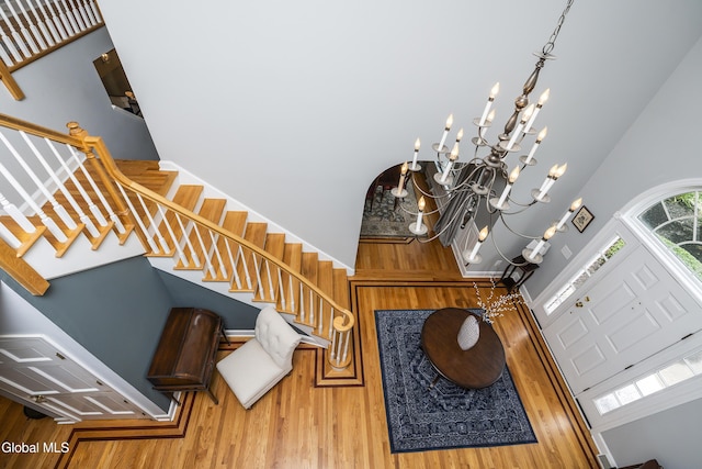 222 Bell Ct, Guilderland, NY 12303 - foyer with a high ceiling, stairs, a chandelier, and wood finished floors