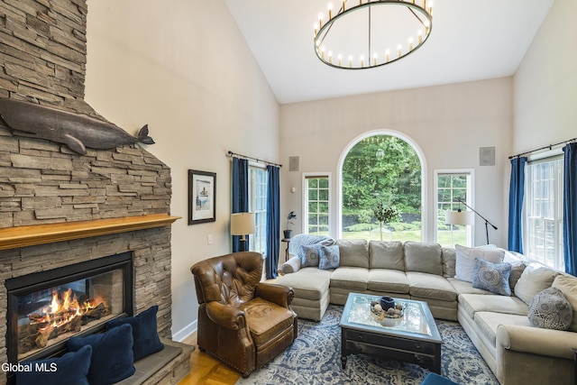 222 Bell Ct, Guilderland, NY 12303 - living room featuring a high ceiling, a chandelier, and a stone fireplace