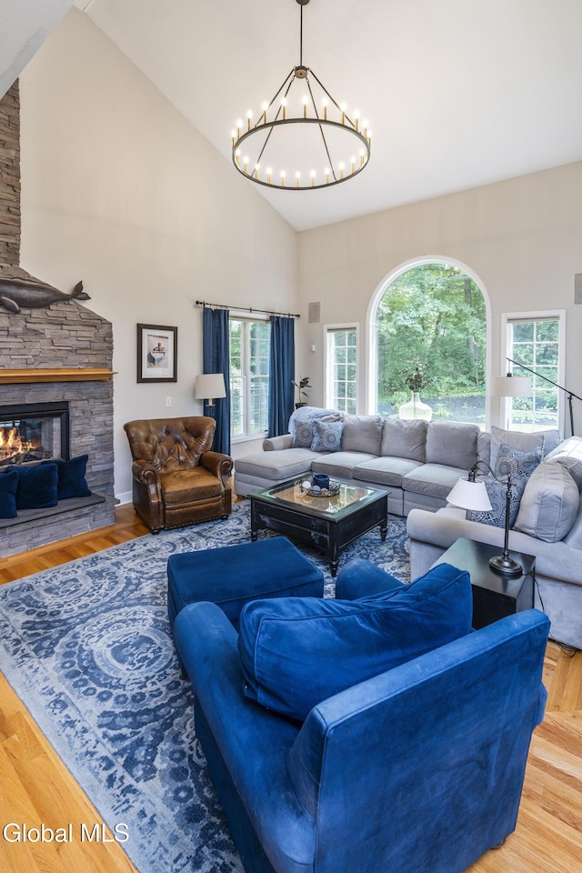 222 Bell Ct, Guilderland, NY 12303 - living area with a chandelier, high vaulted ceiling, healthy amount of natural light, a fireplace, and wood finished floors