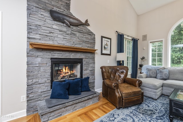 222 Bell Ct, Guilderland, NY 12303 - living room with a stone fireplace, wood finished floors, and high vaulted ceiling