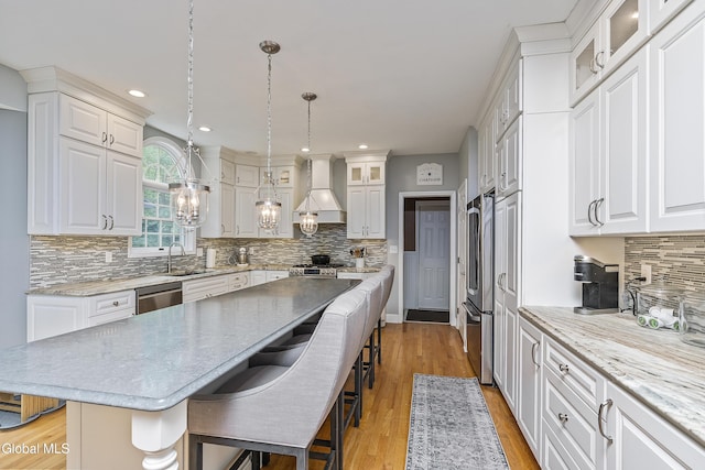 222 Bell Ct, Guilderland, NY 12303 - kitchen with premium range hood, appliances with stainless steel finishes, a kitchen bar, a center island, and white cabinetry