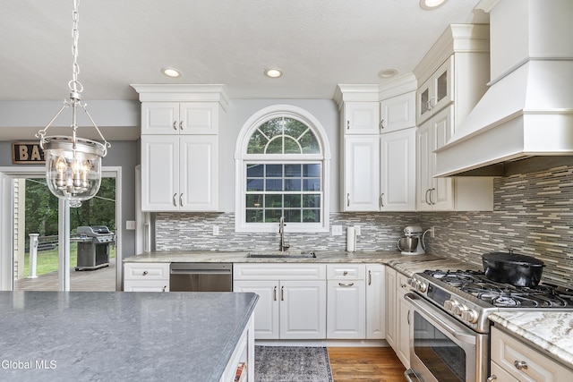 222 Bell Ct, Guilderland, NY 12303 - kitchen with appliances with stainless steel finishes, custom range hood, a chandelier, tasteful backsplash, and recessed lighting