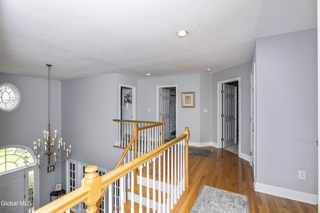 222 Bell Ct, Guilderland, NY 12303 - hallway with an upstairs landing, healthy amount of natural light, wood finished floors, a chandelier, and recessed lighting