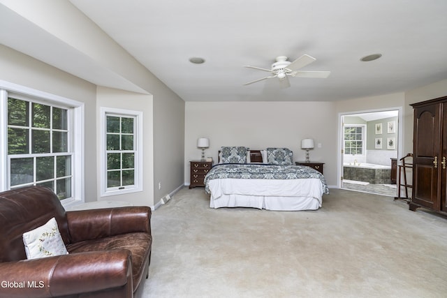 222 Bell Ct, Guilderland, NY 12303 - bedroom with multiple windows, light carpet, ceiling fan, and ensuite bathroom