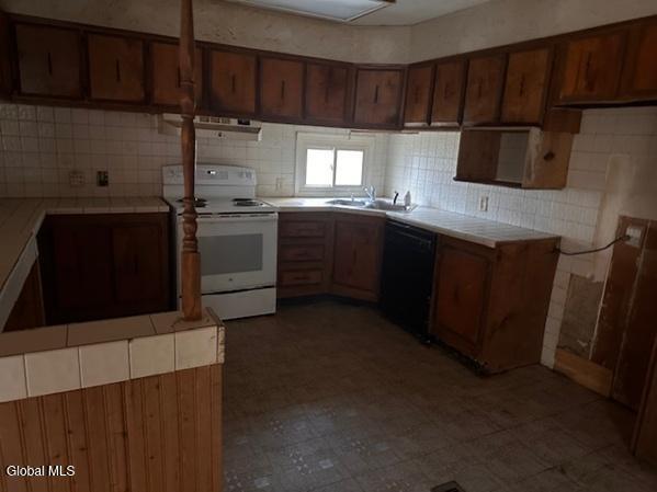 873 W Fulton Rd, Fulton, NY 12187 - kitchen featuring electric stove, black dishwasher, tile counters, and decorative backsplash