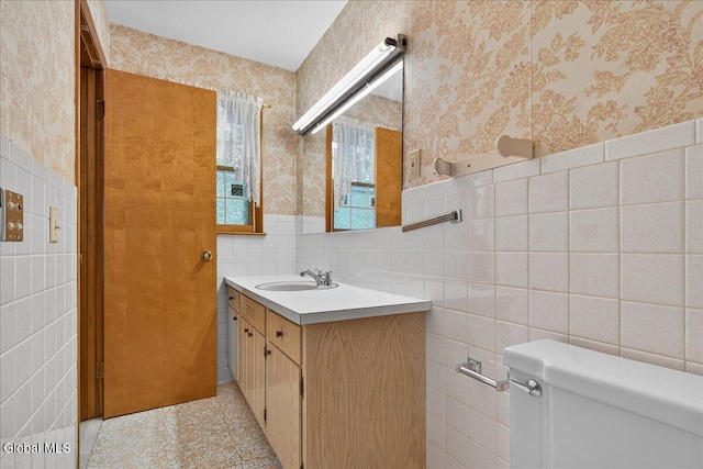 3 Roberts Ln, Saratoga Springs, Inside, NY 12866 - half bathroom with wallpapered walls, tile walls, vanity, and a wainscoted wall