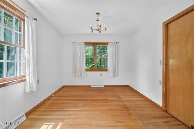 3 Roberts Ln, Saratoga Springs, Inside, NY 12866 - empty room featuring a chandelier, light wood-style flooring, and baseboard heating