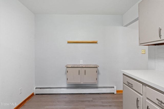 2351 Oakland Ave, Schenectady, NY 12309 - washroom featuring a baseboard radiator and light wood finished floors