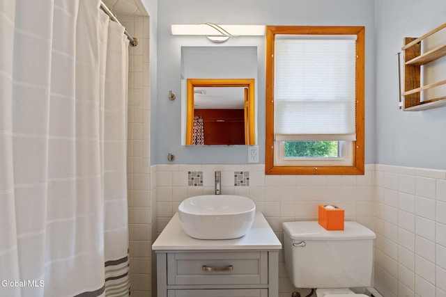 2351 Oakland Ave, Schenectady, NY 12309 - full bath with tile walls, a wainscoted wall, vanity, and curtained shower