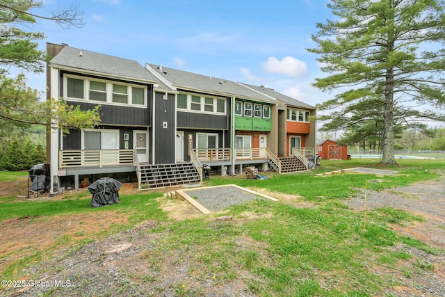 35 Scribner Hollow Rd # E3, Hunter, NY 12442 - rear view of house with a storage shed, roof with shingles, and a wooden deck