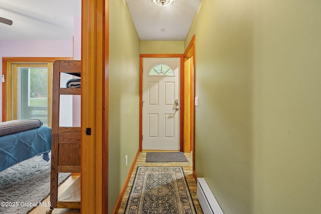 35 Scribner Hollow Rd # E3, Hunter, NY 12442 - doorway to outside with healthy amount of natural light, a baseboard radiator, and dark wood-type flooring