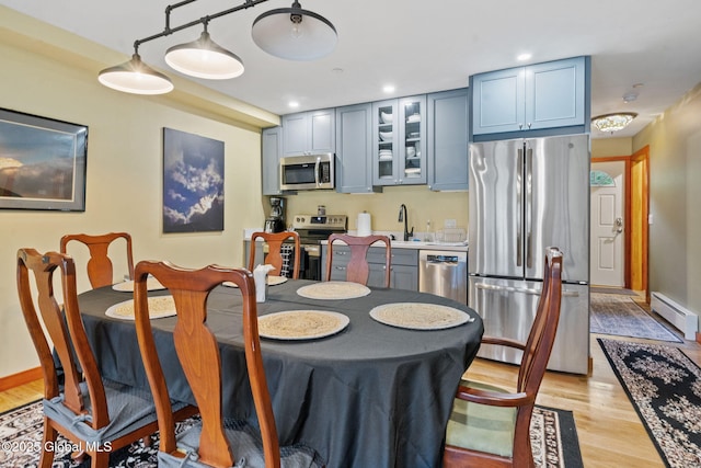 35 Scribner Hollow Rd # E3, Hunter, NY 12442 - dining space featuring a baseboard heating unit and light wood-style floors