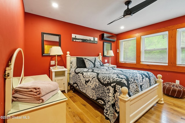 35 Scribner Hollow Rd # E3, Hunter, NY 12442 - bedroom featuring a wall mounted AC, wood finished floors, recessed lighting, and a ceiling fan