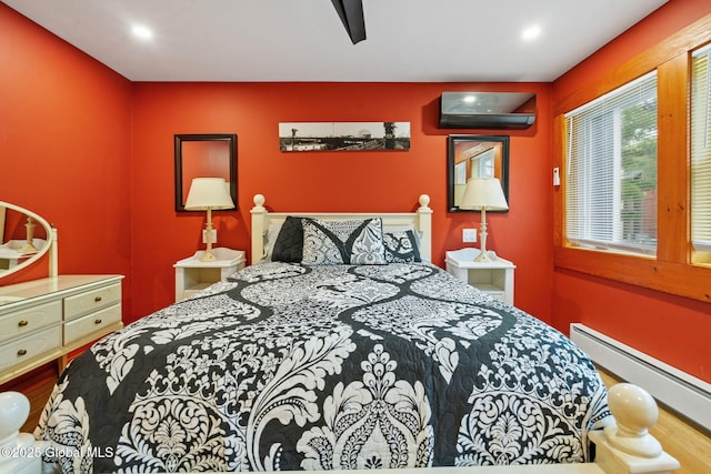 35 Scribner Hollow Rd # E3, Hunter, NY 12442 - bedroom with baseboard heating, an AC wall unit, and recessed lighting